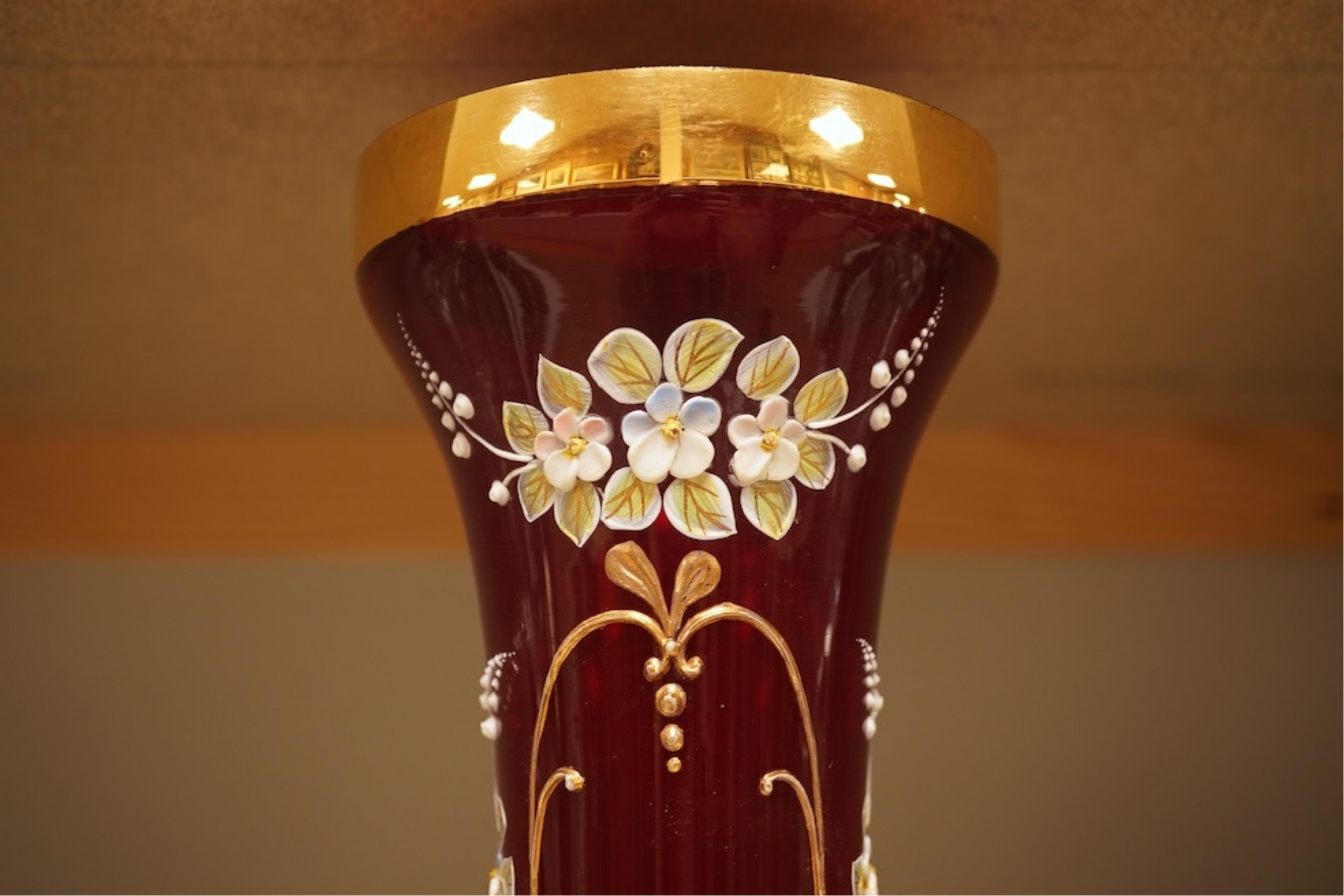 A pair of Victorian glass decanters, later stoppers, and an enamelled ruby glass vase, latter 32cm high
